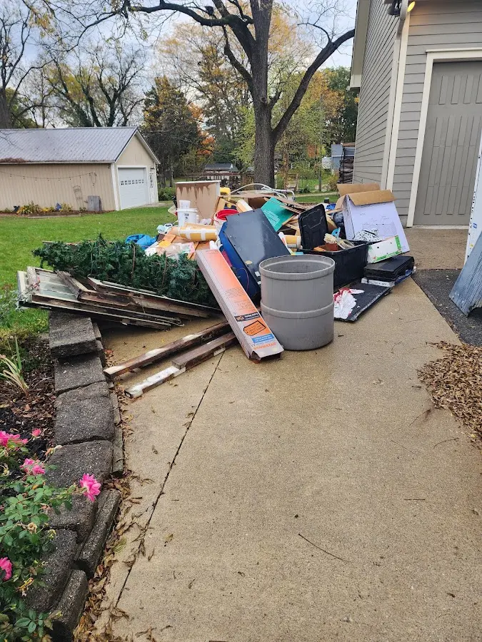 Dumpster being loaded with debris for Estate Cleanout Dumpster Rental in Osage Beach